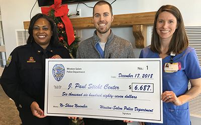 Winston Salem Police Department presents check to Sticht Center for Aging and Rehabilitation
