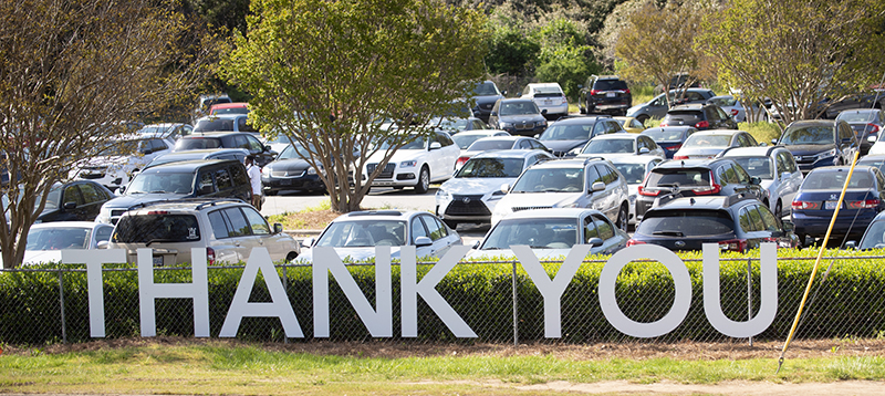 Thank You sign on the fence of parking lot.