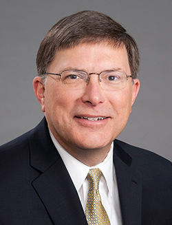 head shot of white male wearing glasses