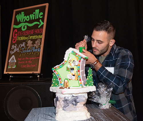 Pastry chef Jordan Pilarski demonstrates gingerbread house decorating at Cheers! 2018