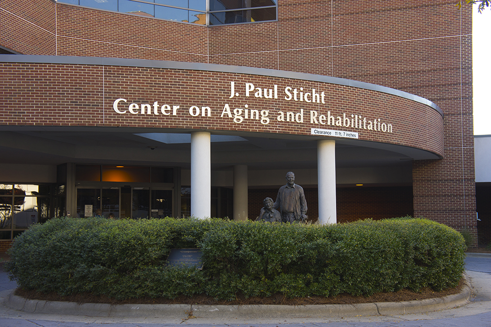 Front of Sticht Center, a red brick building with covered pull-around for dropping off patients