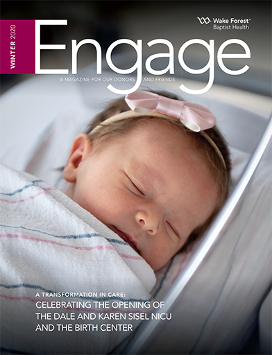 Close-up of newborn on cover of Engage magazine