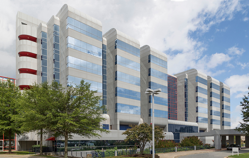 Exterior view of High Point Medical Center with blue sky and clouds in background