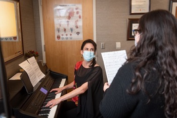 Amy Morris at piano with patient.