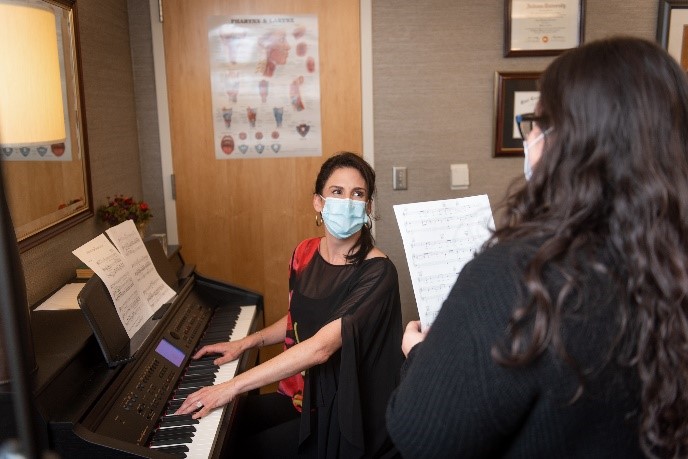 Amy Morris at piano with patient.