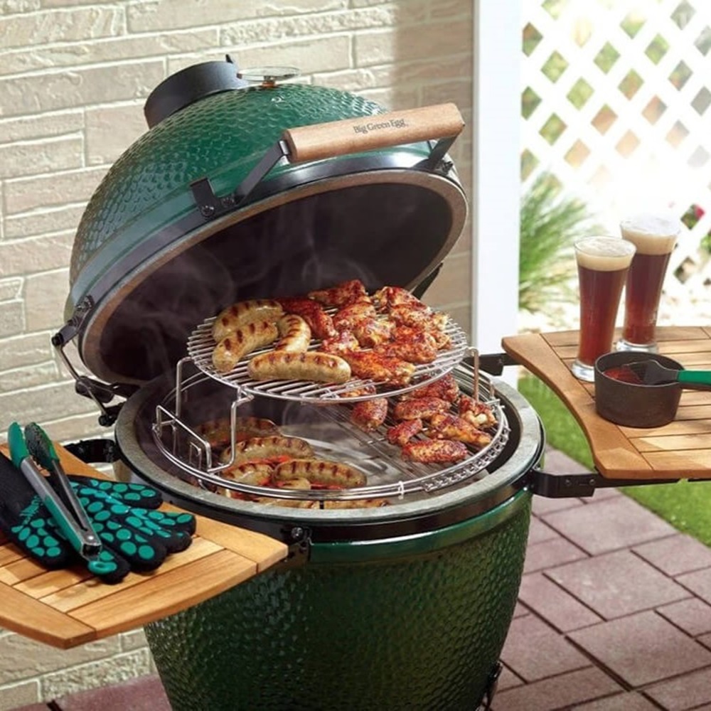 A green grill cooking a collection of different foods.