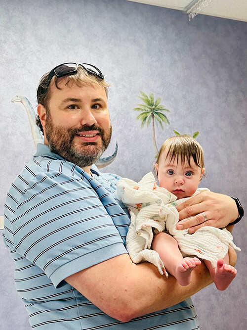 A man holding a baby.