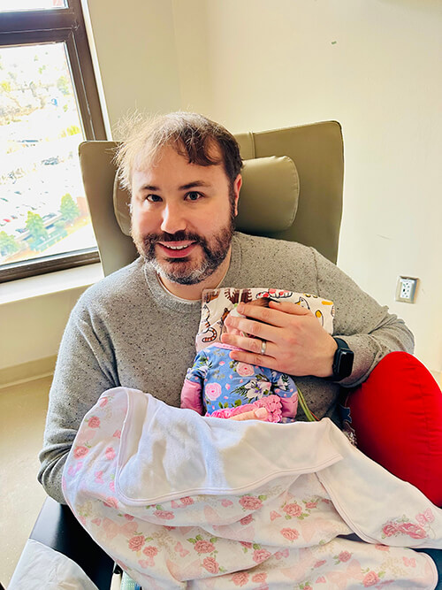 A man holding a baby.