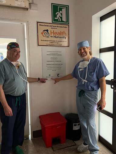 James Mooney, MD, and John Frino, MD,stand together during one of their medical mission trips.