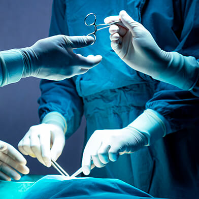 Medical providers performing a surgery in a hospital.