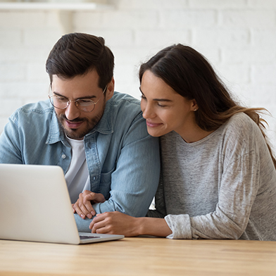 Couple looking at laptop for health insurance