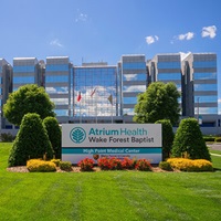 The exterior of an office building with a sign that reads Atrium Health Wake Forest Baptist High Point Medical Center.