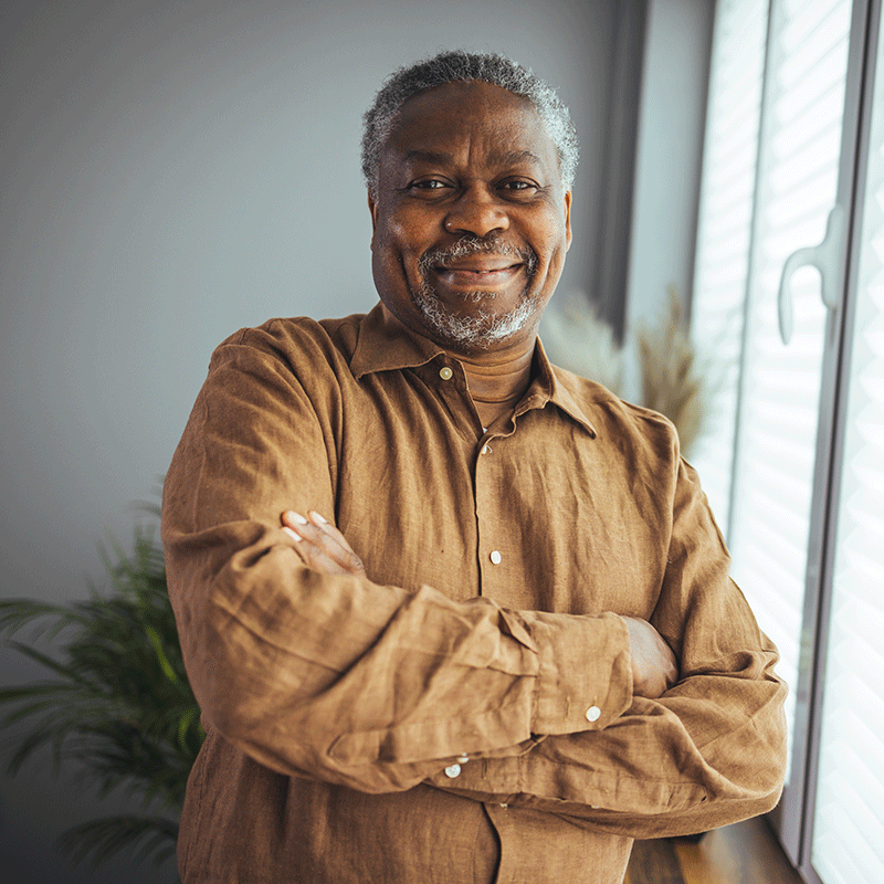 Older Man Standing in Front of Window