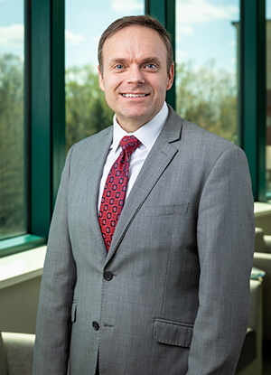 Brian Vannoy wearing a suit, smiling at the camera