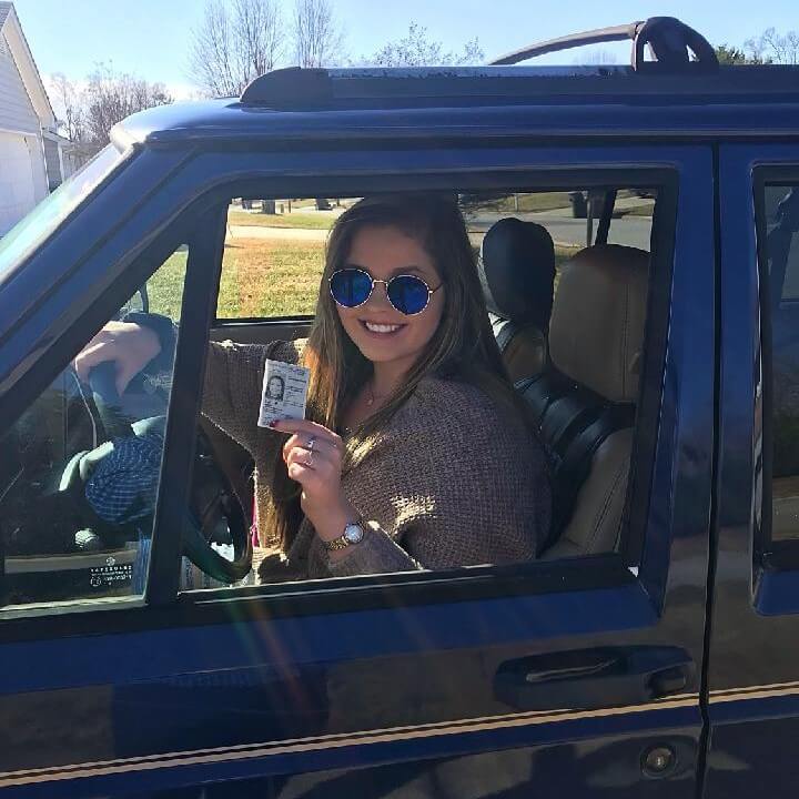 Former patient with keys to dream car sitting in car