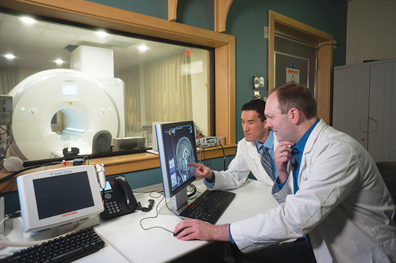 Two medical professionals looking at medical equipment.