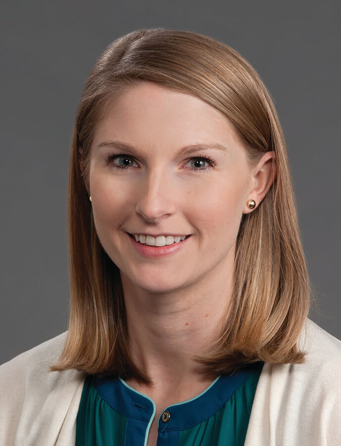 A woman with shoulder-length hair smiling at the camera.