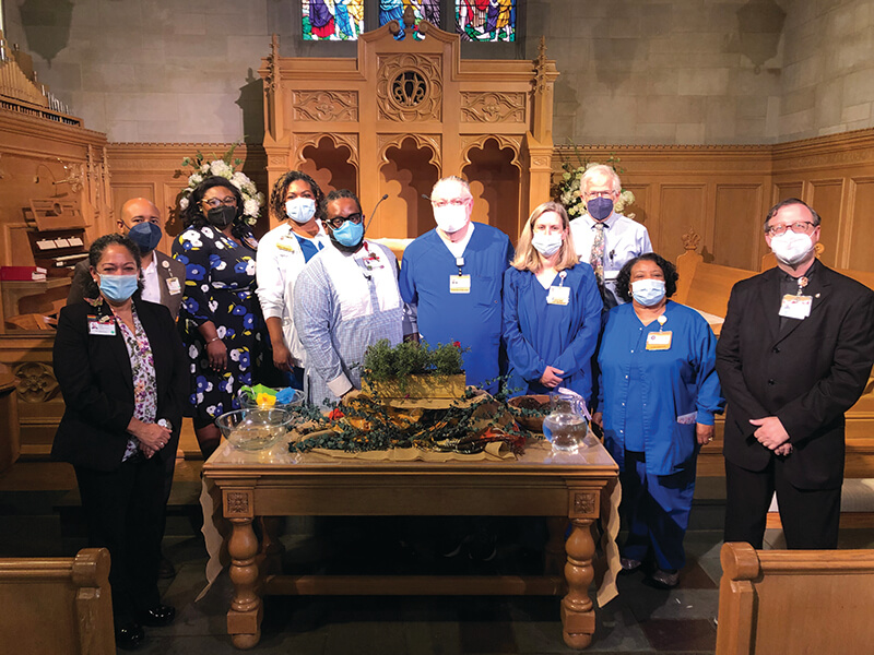 A group of medical professionals standing side-by-side and looking at the camera.