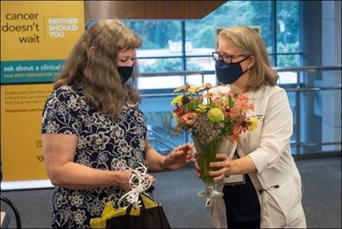 Cathy, a T-cell lymphoma survivor who received a bone marrow transplant four years ago, was gifted flowers from her physician, Dianna Howard, M.D., professor of hematology and oncology.