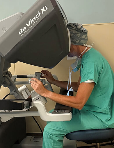 A medical surgeon controlling a robotic surgery device.