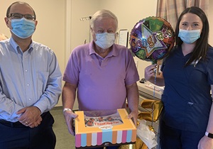 Left to right: George Yacoub, M.D., assistant professor of hematology and oncology, Groce and Kristin Houston, P.A. Groce brought a cake as a ‘thank you’ to his care team.
