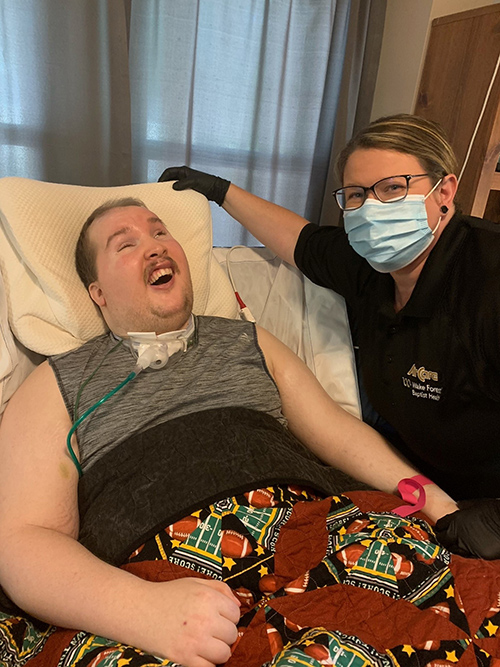 Landon Walker at home with his mother. 