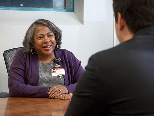 Rev. Bradley talking with a patient. 