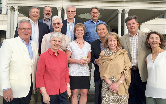Ten members of the Internal Medicine House Staff Class of 1984 stand on steps in front of building