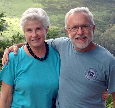 Marcia Farrar, PA '75, stands with her husband at an overlook in Hawaii