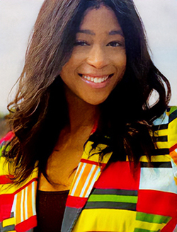 Head shot of smiling woman with long dark hair and wearing a brightly colored jacket