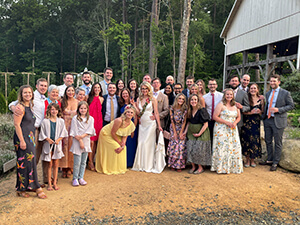 A group of people posing at a wedding.