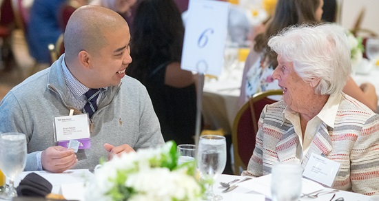 MD student talks with an alumnae at 2018 Scholarship Brunch during MD Alumni Weekend.