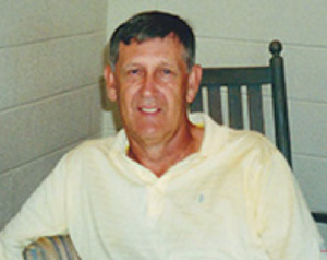 Kelly Taylor, PA-C '71, sits in a rocking chair