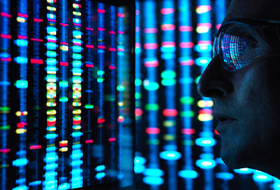 Stock photo of man wearing sunglasses in blue light with multicolored lights in background