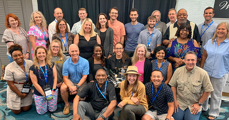 A group photo of people at a luncheon.