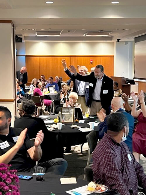 A group of people clapping for an audience member.