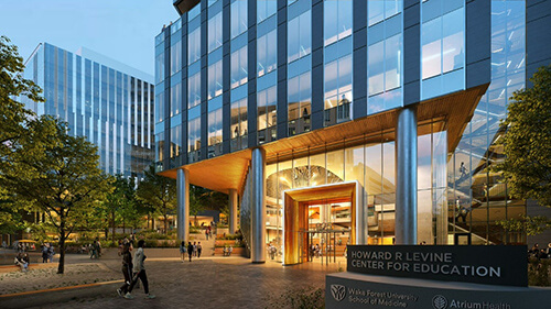 The front of an office building with a sign that reads Howard R Levine Center for Education.