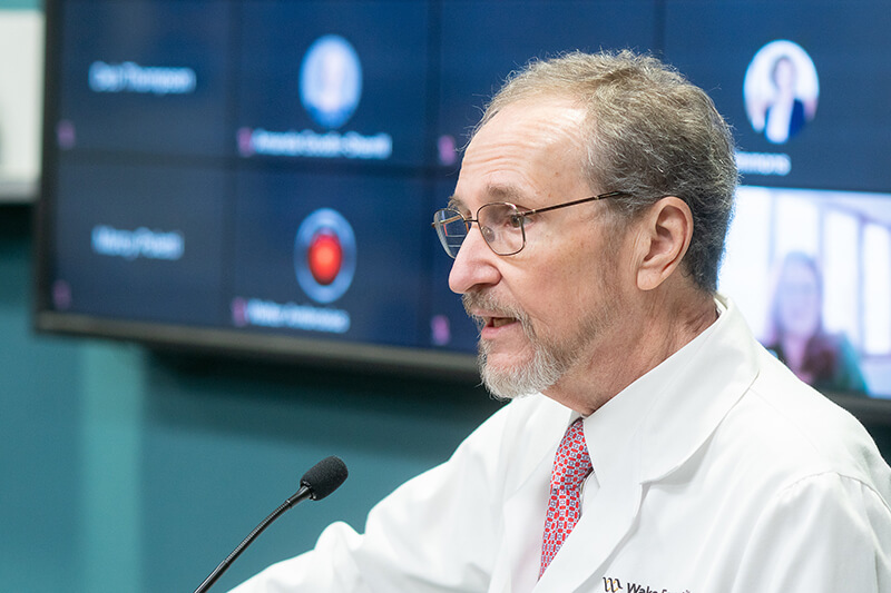 A medical professional speaking at a conference.