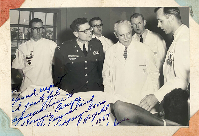 A black and white photo of a group of medical professionals.