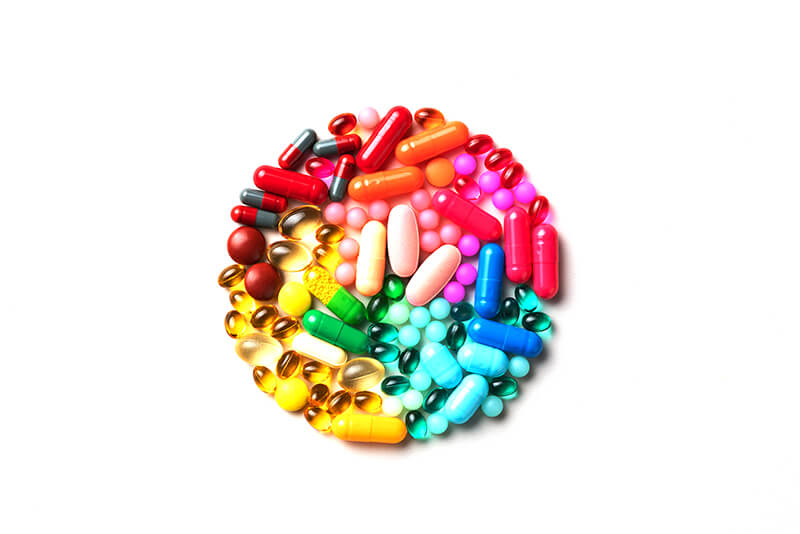 A circle of multi-colored pills.