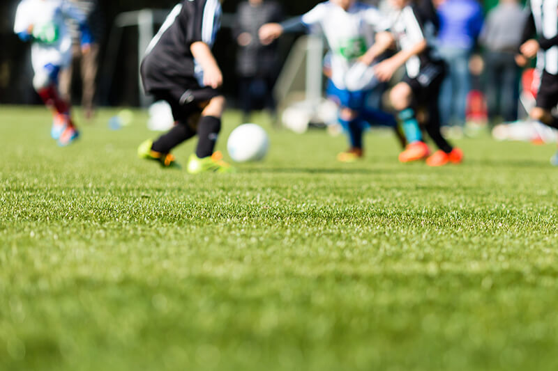 A group of people playing soccer.