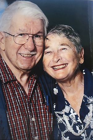 Older couple hugs and smiles