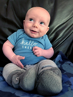 Baby boy smiles as he looks up