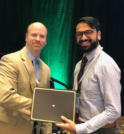 Parag Chevli receives an award for the best oral case presentation on his abstract at the 2019 Perioperative Medicine Summit in Orlando, Florida.
