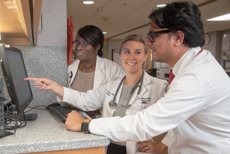 trio of hospitaists with monitor