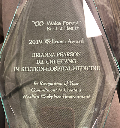 Clear glass award trophy with inscription