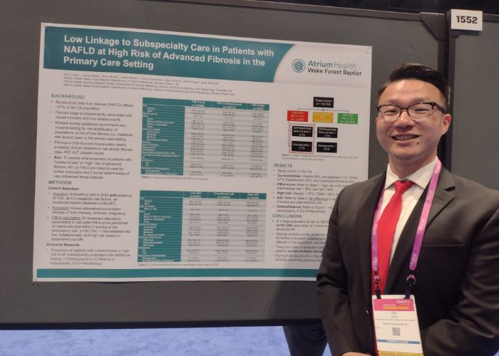 Ted Xiao in front of academic poster.