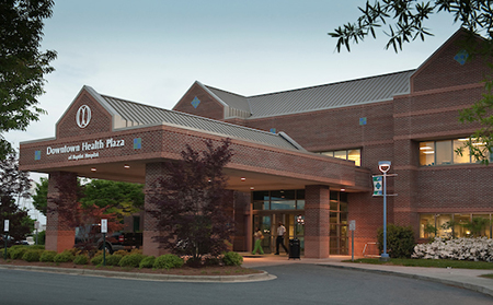 exterior of red brick building with pull-around covered area