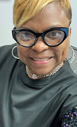 Blonde African American woman smiles at camera