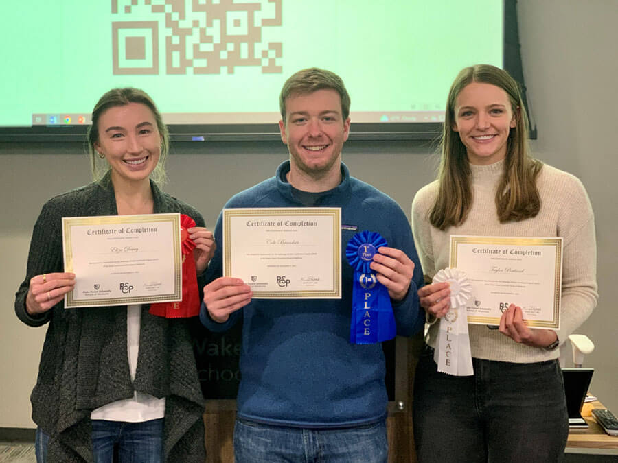 Three students showing their certificates for completing the Radiology Scholar Certificate Program.